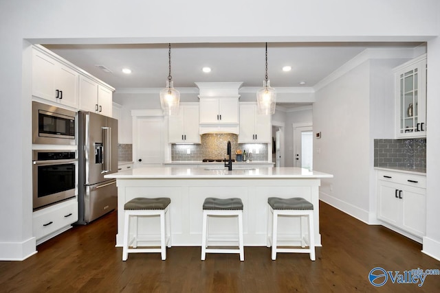 kitchen featuring dark wood-type flooring, appliances with stainless steel finishes, light countertops, and white cabinetry
