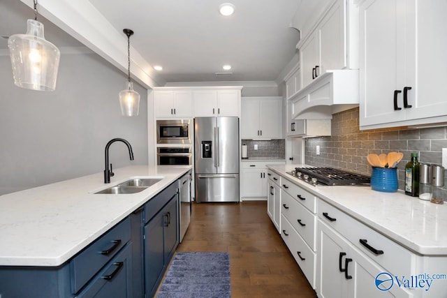 kitchen with a sink, white cabinetry, blue cabinetry, and stainless steel appliances