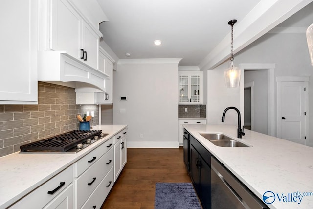 kitchen featuring custom exhaust hood, white cabinets, a sink, appliances with stainless steel finishes, and light stone counters