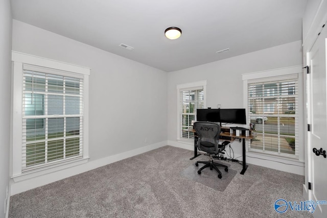 carpeted home office with visible vents and baseboards