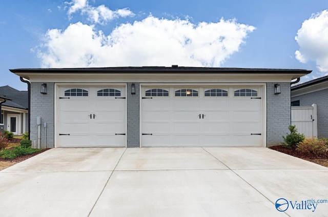 garage featuring concrete driveway