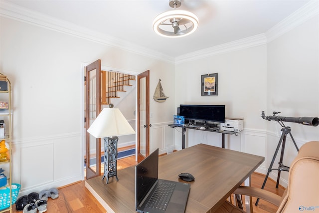 office featuring ceiling fan, light wood-type flooring, french doors, and ornamental molding