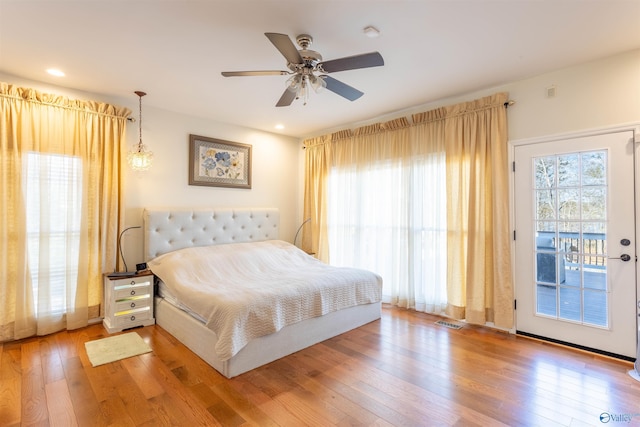 bedroom with hardwood / wood-style flooring, access to outside, and ceiling fan