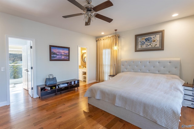 bedroom featuring ceiling fan, ensuite bathroom, and hardwood / wood-style floors