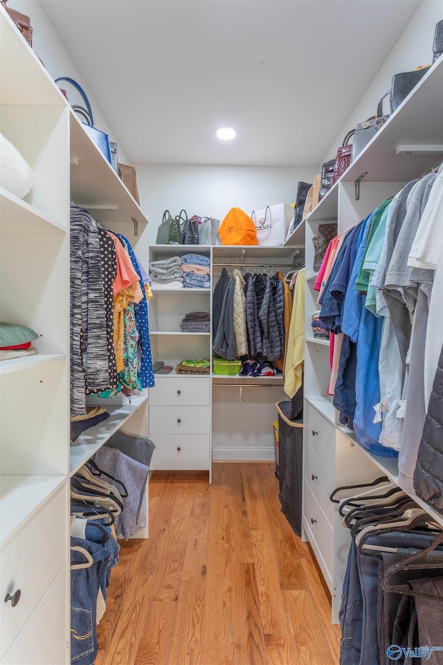 walk in closet featuring light hardwood / wood-style flooring