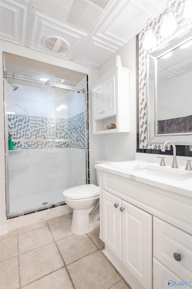 bathroom featuring vanity, toilet, tile patterned flooring, and a shower with door