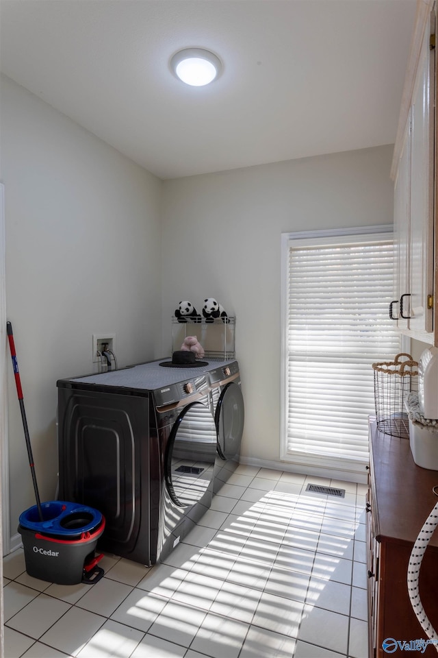 laundry area with light tile patterned floors and independent washer and dryer