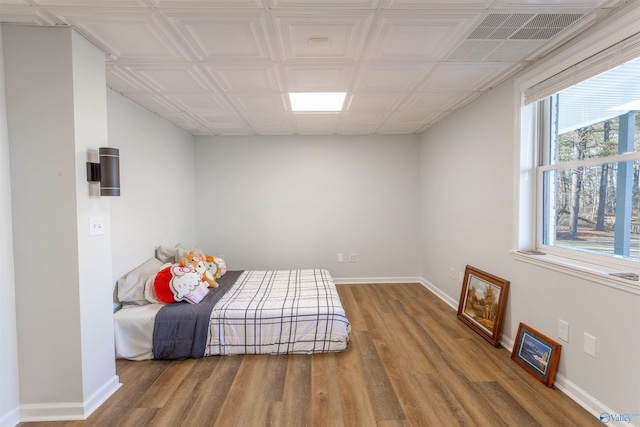 bedroom with hardwood / wood-style flooring