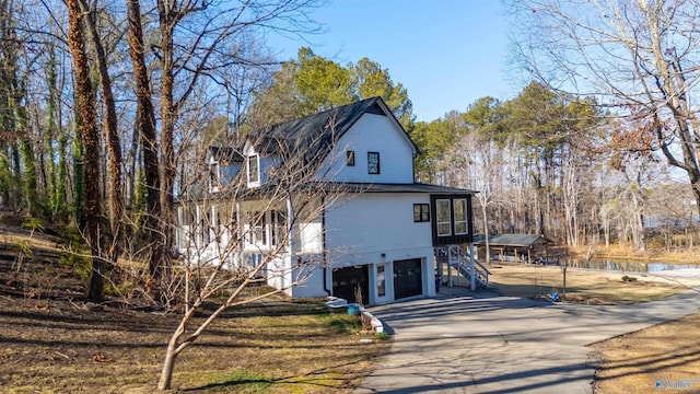 rear view of property with a garage