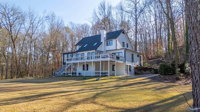 view of front facade with a front lawn and a deck