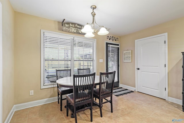 dining room featuring a notable chandelier and light tile patterned flooring