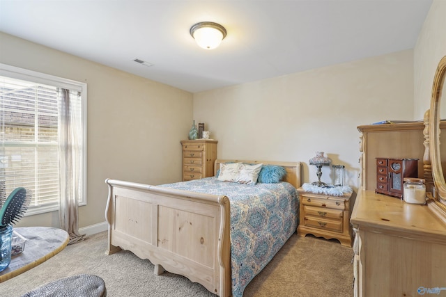 bedroom featuring light colored carpet, baseboards, and visible vents