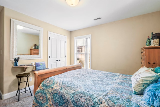 carpeted bedroom with a closet