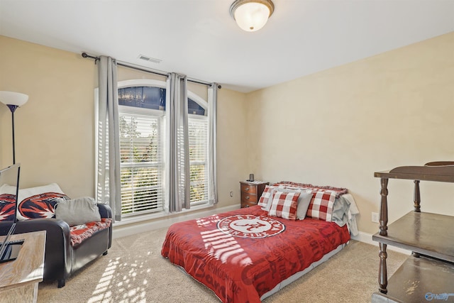 bedroom featuring baseboards, visible vents, and carpet floors