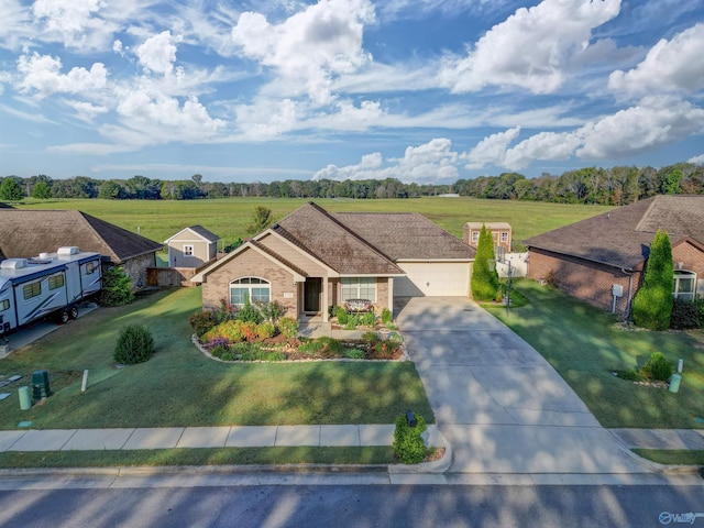 single story home featuring driveway, a front lawn, and brick siding