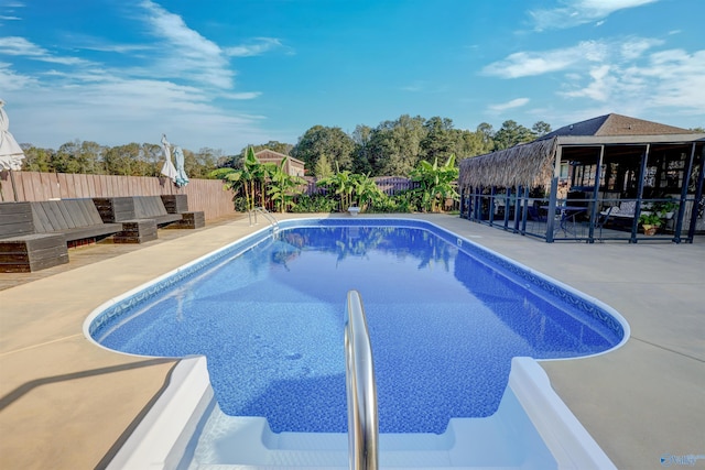 view of pool featuring a fenced backyard, a fenced in pool, and a patio area