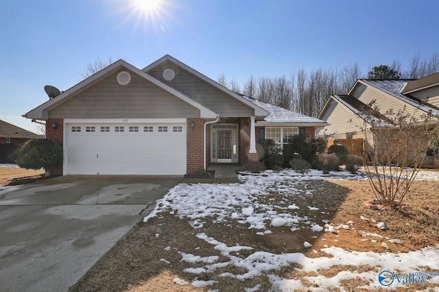 view of front of home with a garage, concrete driveway, and brick siding