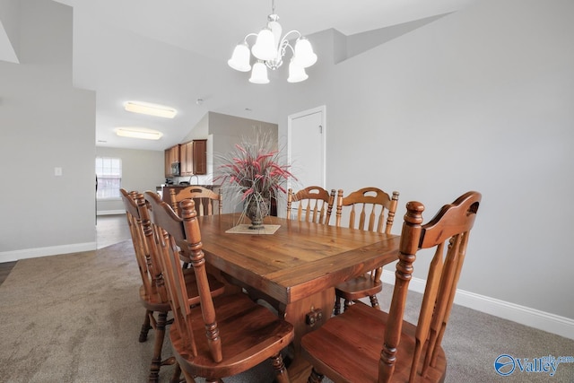 dining room with an inviting chandelier, vaulted ceiling, and carpet