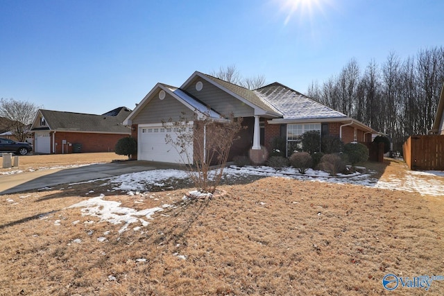 view of front facade featuring brick siding, driveway, and an attached garage