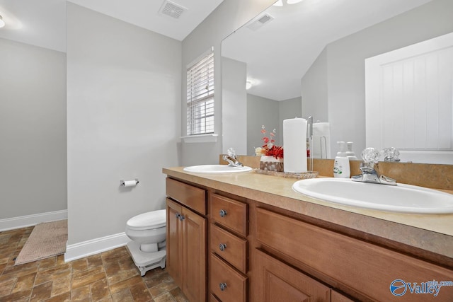 bathroom featuring toilet and vanity