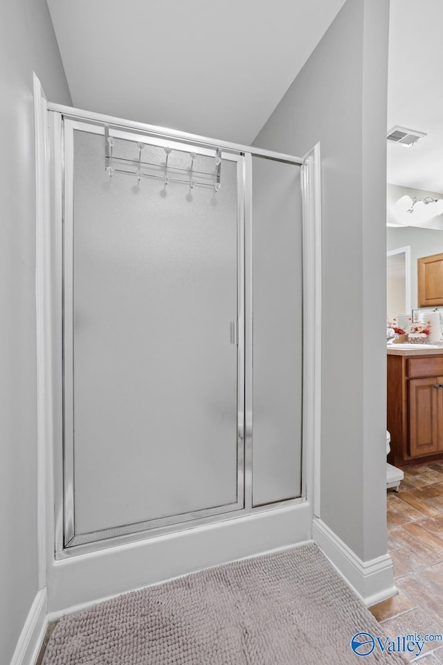 bathroom featuring vanity and walk in shower