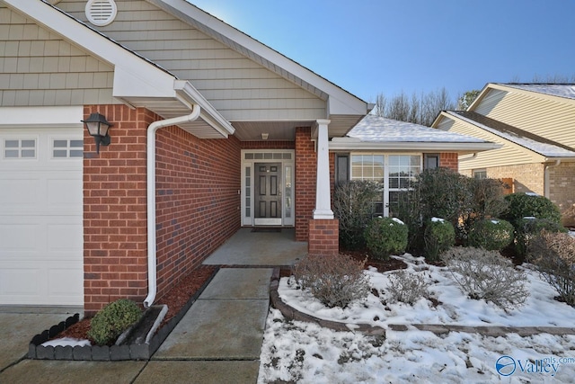 view of snow covered property entrance