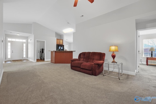 carpeted living room with vaulted ceiling and ceiling fan