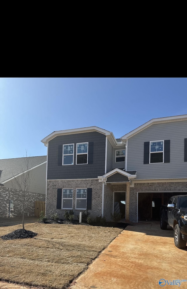 view of front of house with a garage, driveway, and fence