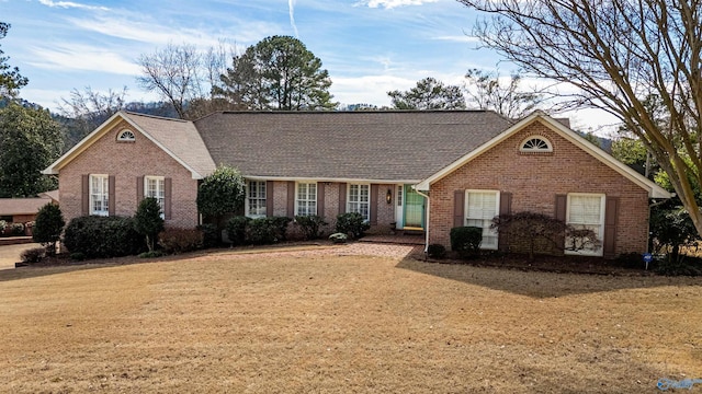 view of front of house with a front yard and brick siding