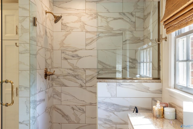 bathroom with a healthy amount of sunlight and a shower stall