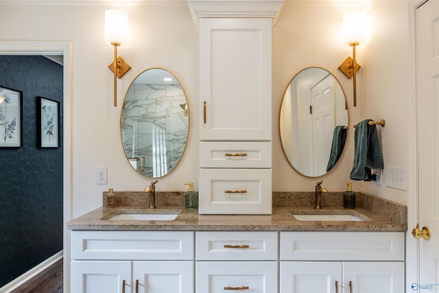 bathroom featuring double vanity, a sink, and wood finished floors