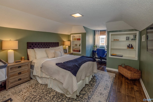bedroom with a textured ceiling, vaulted ceiling, and dark wood-style flooring