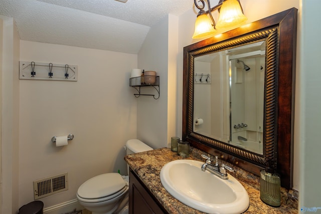 bathroom featuring visible vents, toilet, vaulted ceiling, vanity, and a textured ceiling