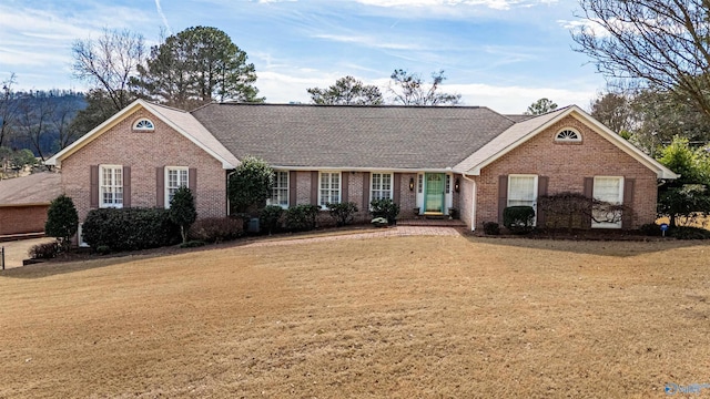 view of front of property featuring a front lawn and brick siding