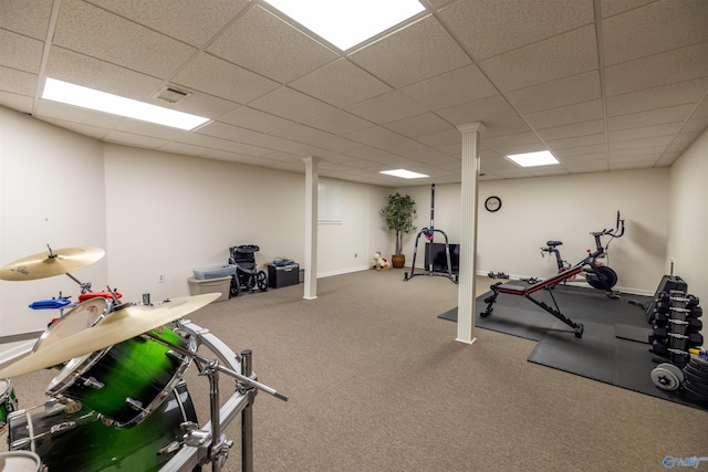 workout room with baseboards, visible vents, and a drop ceiling