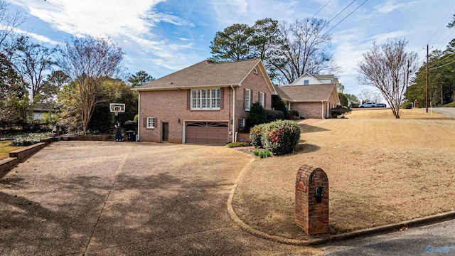 view of home's exterior with concrete driveway, brick siding, and an attached garage