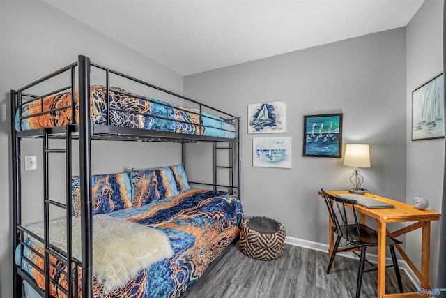bedroom with baseboards and wood finished floors