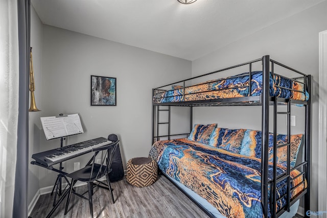 bedroom with baseboards and wood finished floors