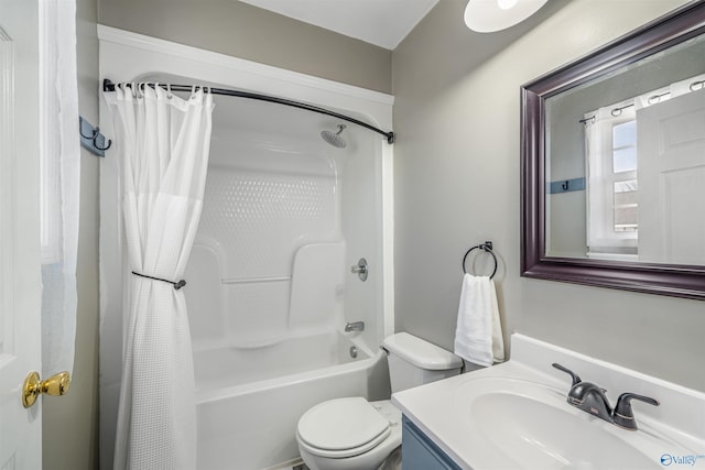 bathroom featuring toilet, shower / bath combo with shower curtain, and vanity