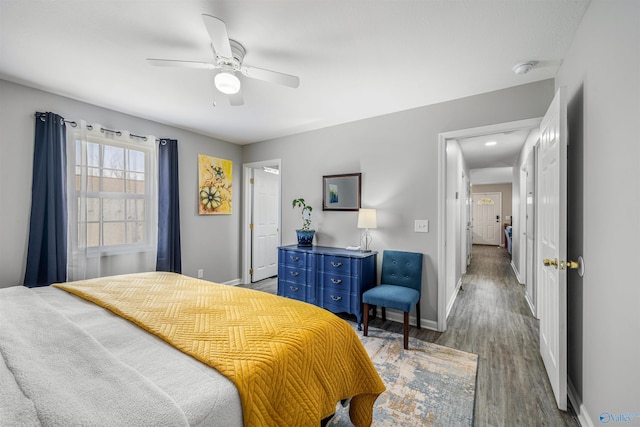 bedroom featuring baseboards, ceiling fan, and wood finished floors