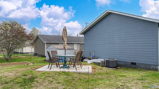 back of property featuring a patio area, crawl space, an outbuilding, central AC unit, and a lawn