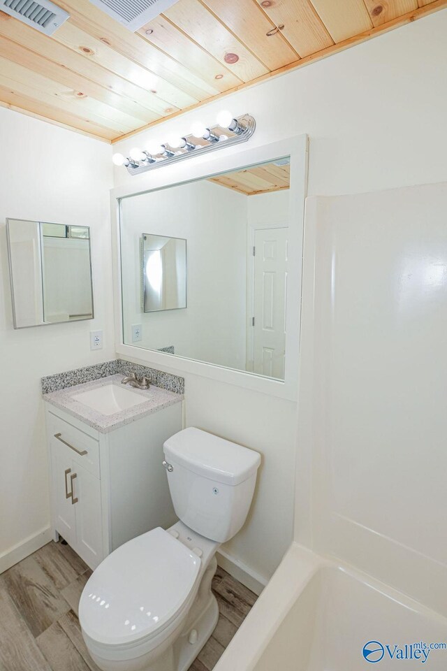 full bathroom featuring wood ceiling, toilet, hardwood / wood-style floors, and vanity