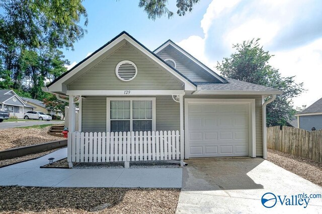 view of front of property with covered porch and a garage