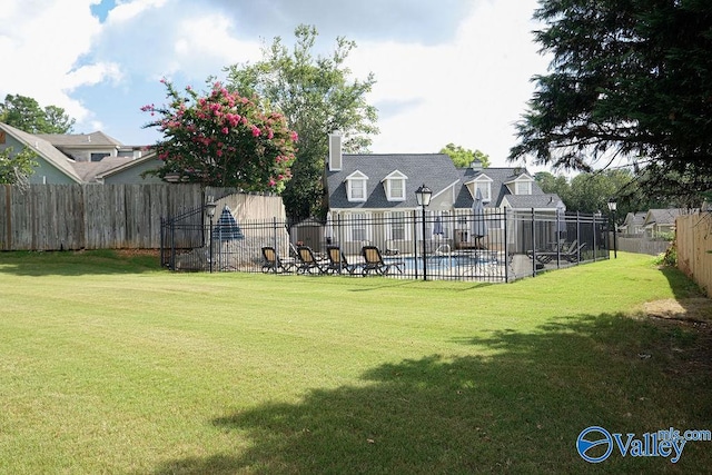 view of yard with a fenced in pool