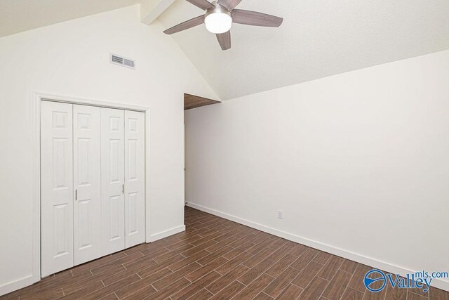 unfurnished bedroom with high vaulted ceiling, dark hardwood / wood-style flooring, beamed ceiling, a closet, and ceiling fan