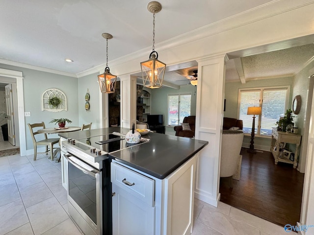 kitchen with pendant lighting, white cabinetry, light hardwood / wood-style flooring, and electric stove