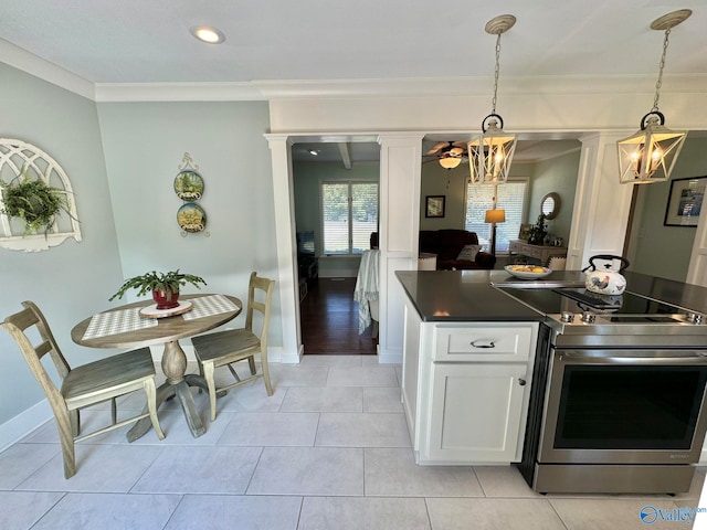 kitchen featuring pendant lighting, ornamental molding, stainless steel range with electric cooktop, a chandelier, and white cabinets