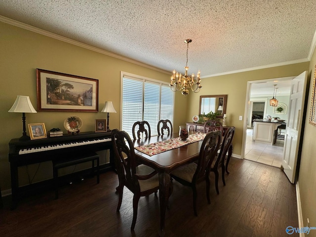 dining area featuring a textured ceiling, crown molding, a notable chandelier, and dark hardwood / wood-style flooring