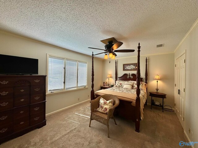 bedroom with a textured ceiling, crown molding, ceiling fan, and carpet floors