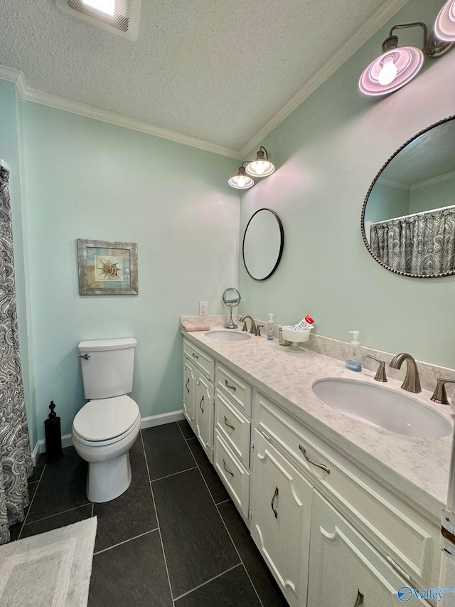 bathroom featuring a textured ceiling, vanity, toilet, ornamental molding, and tile patterned floors